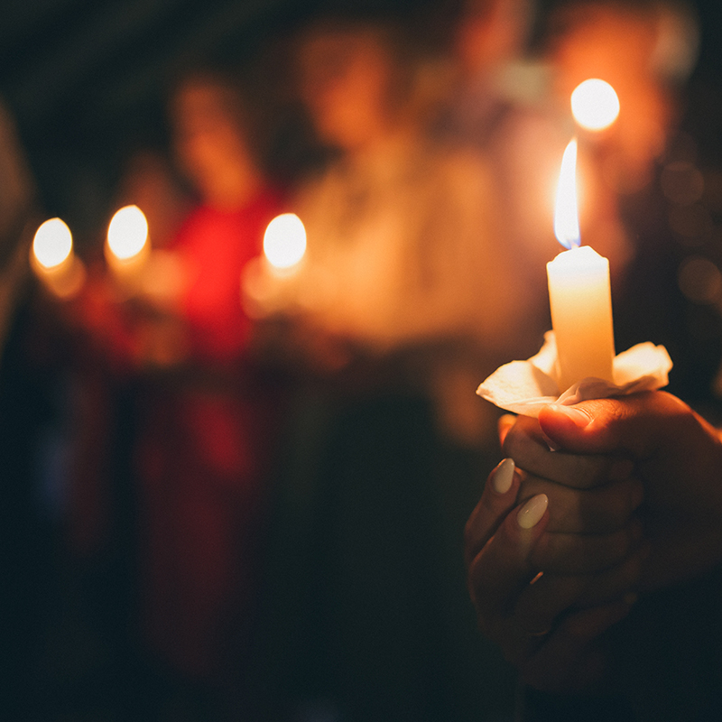 hand holding orthodox candles